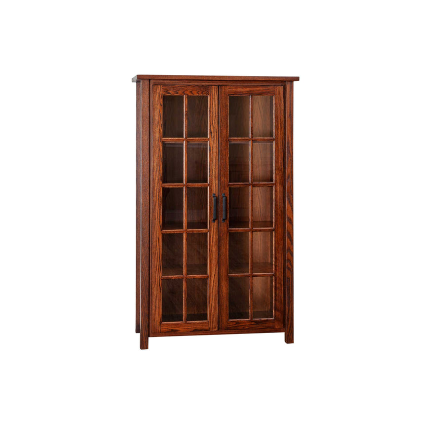 Five foot oak bookcase with two glass mullion doors, four interior shelves and a black vertical pull, angled view