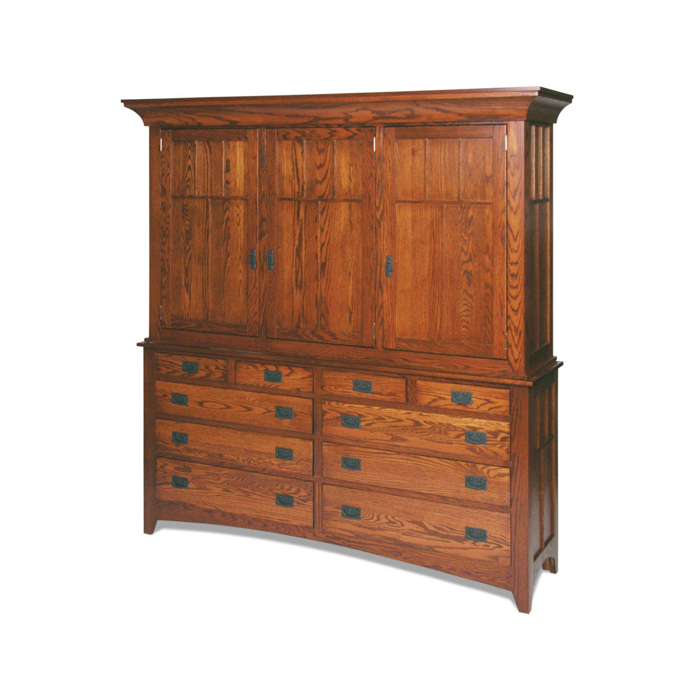 Large Mission oak mule chest with four upper doors above ten drawers, staged in a bedroom with lamp and plant