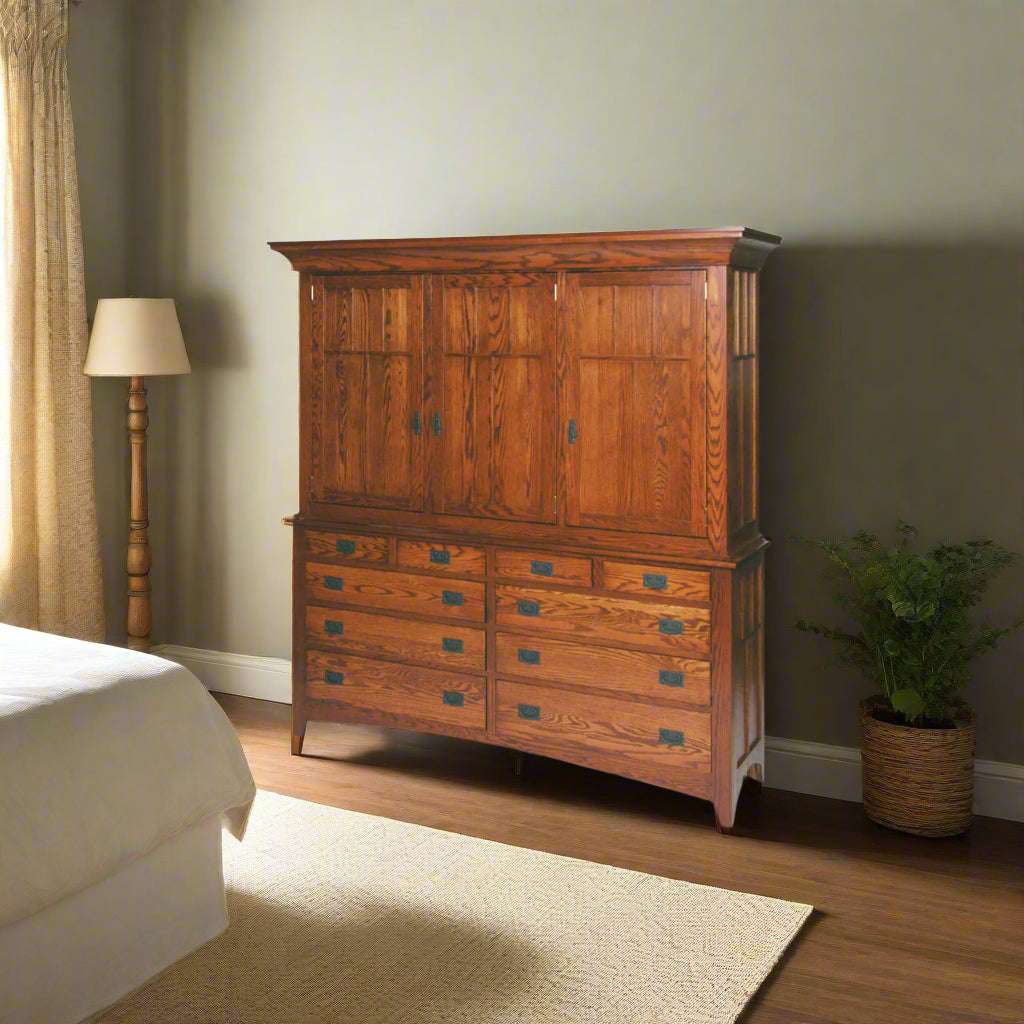 Large Mission oak mule chest with four upper doors above ten drawers, staged in a bedroom with lamp and plant