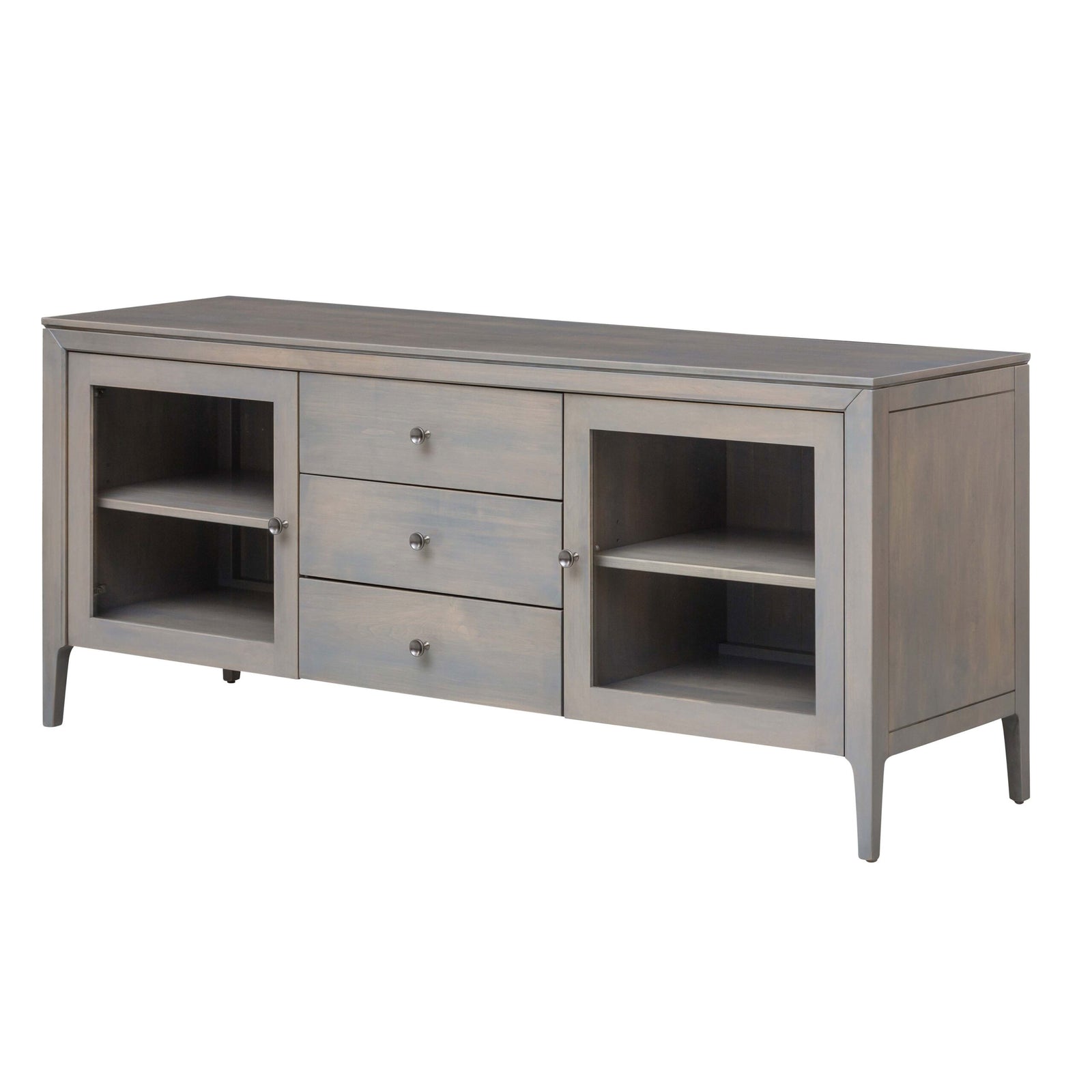 Low mid century tv stand in a gray wash finish with three center drawers and two glass door cabinets with shelves