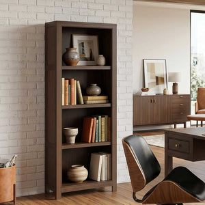 Tall narrow bookcase in dark walnut with four open shelves holding books and pottery against a white brick wall
