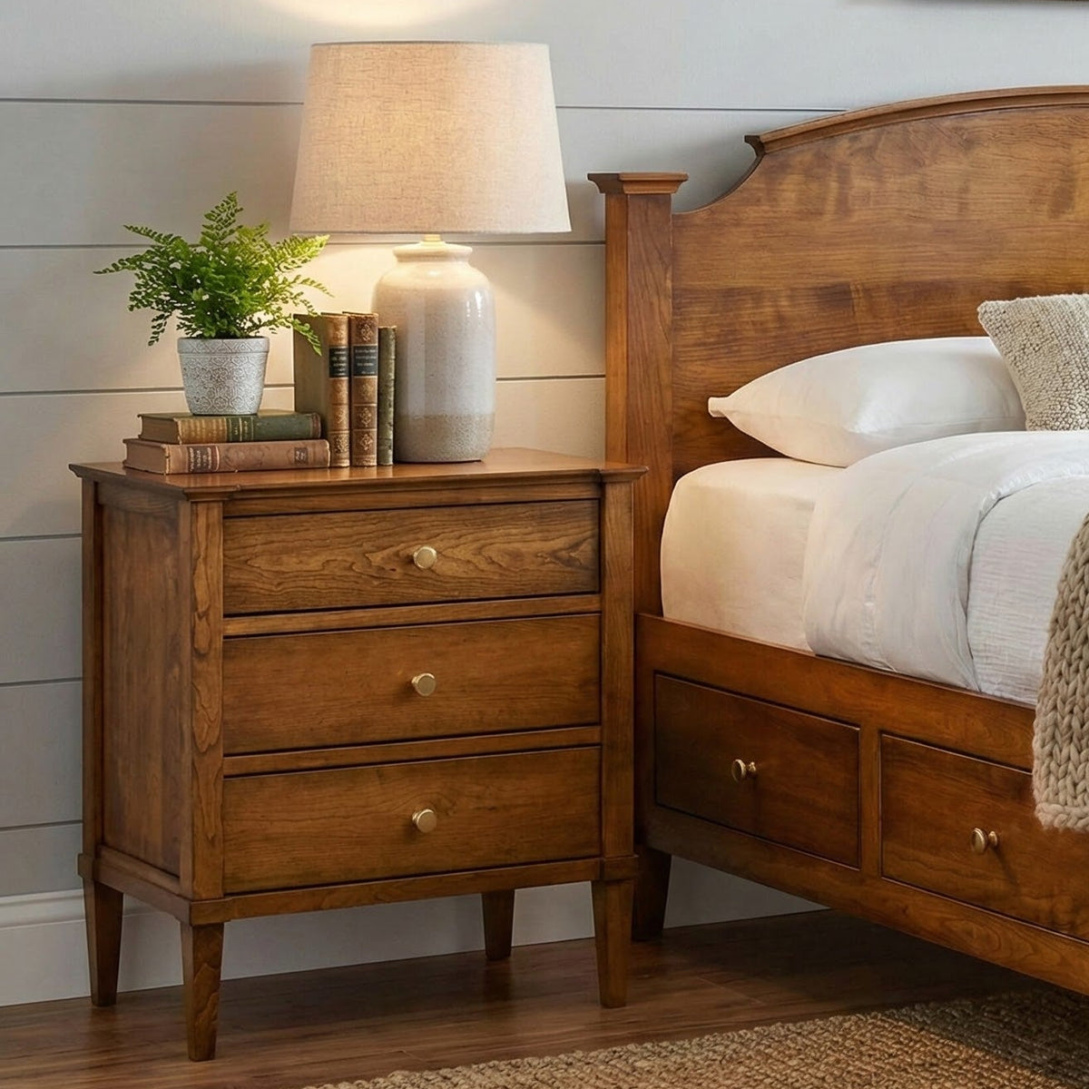 Wooden bed and nightstand in a bedroom with a lamp and decor items.