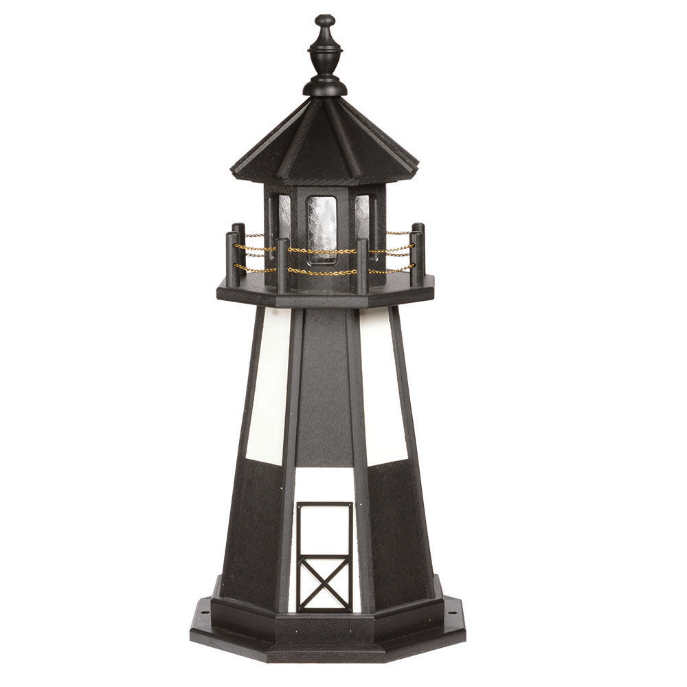 Black wooden lighthouse with white panel windows, black lantern room, gold chain railing and door frame detail