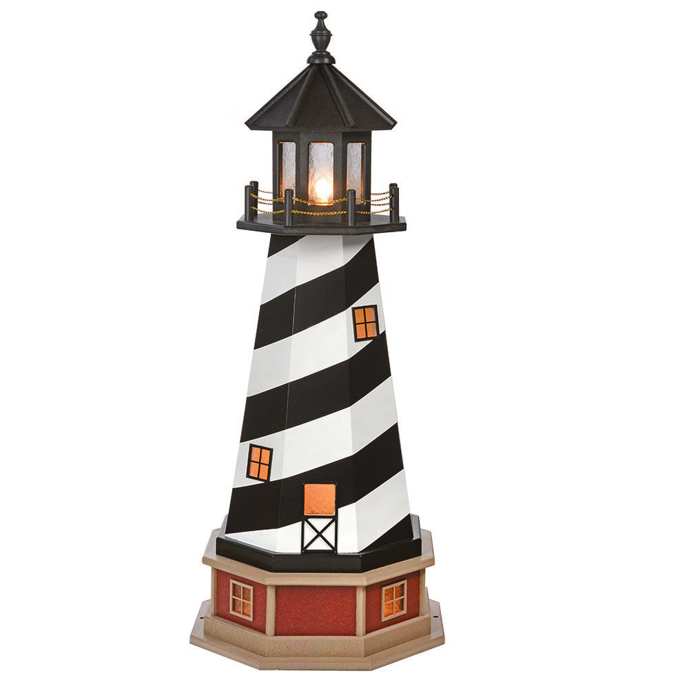 Black and white spiral striped lighthouse with glowing lantern room and lit amber windows on a red and tan base