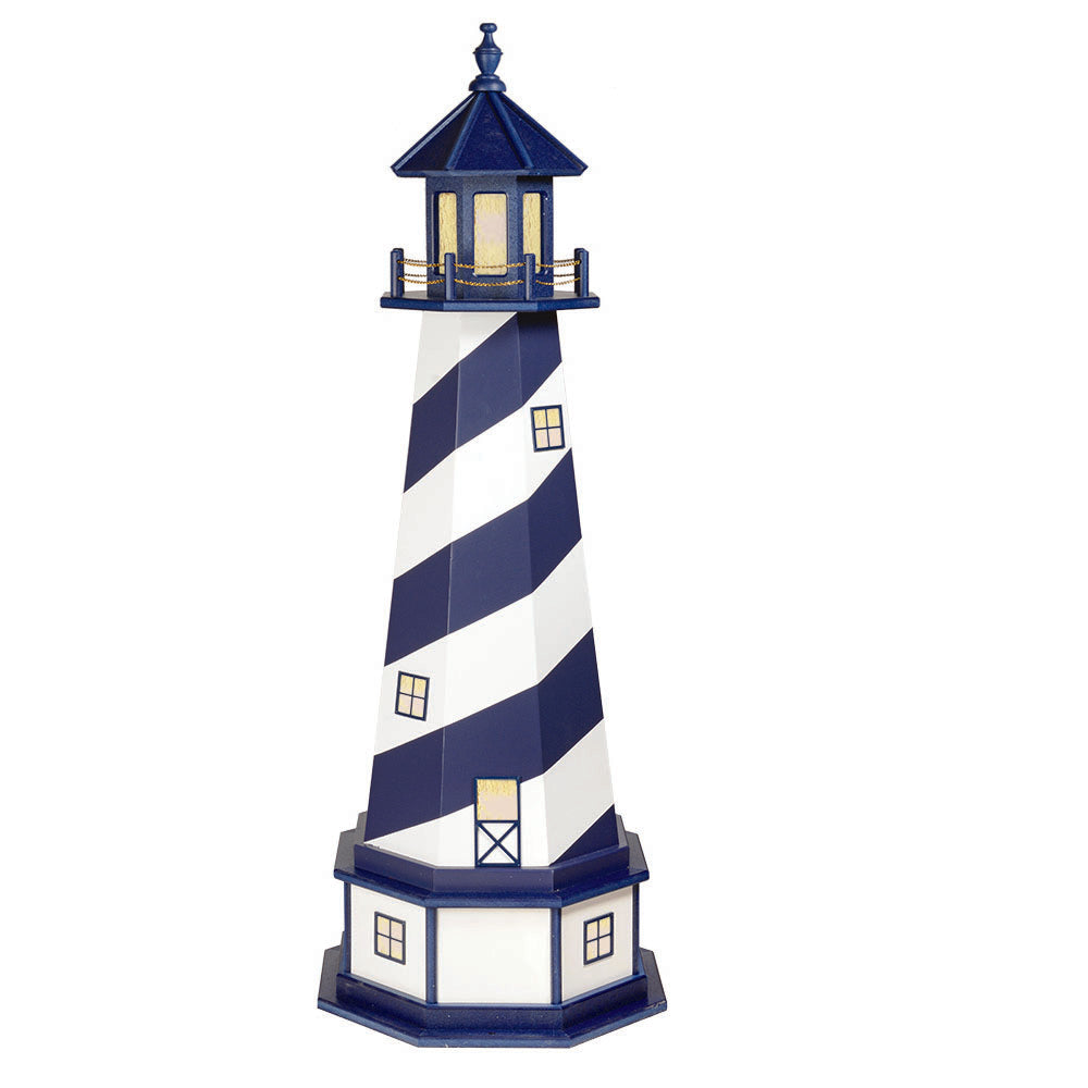 Navy and white spiral striped lighthouse with lit amber windows, blue lantern room and a white paneled base