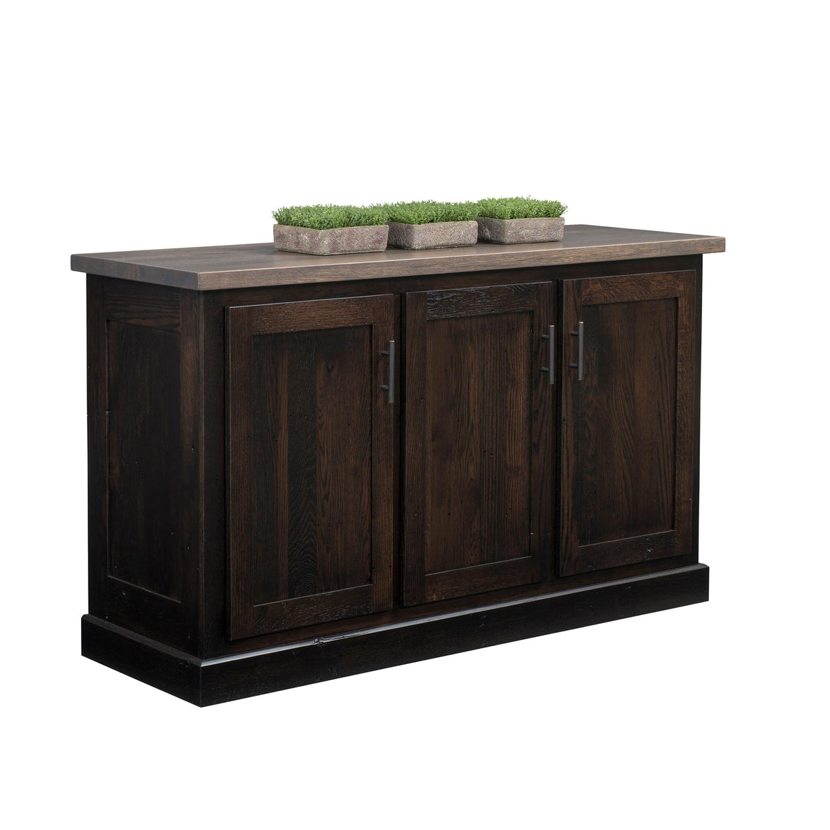 A dark brown wooden sideboard or buffet cabinet with three paneled doors and a rustic gray-brown top surface, shown on a plain white background with three small potted green plants on top.