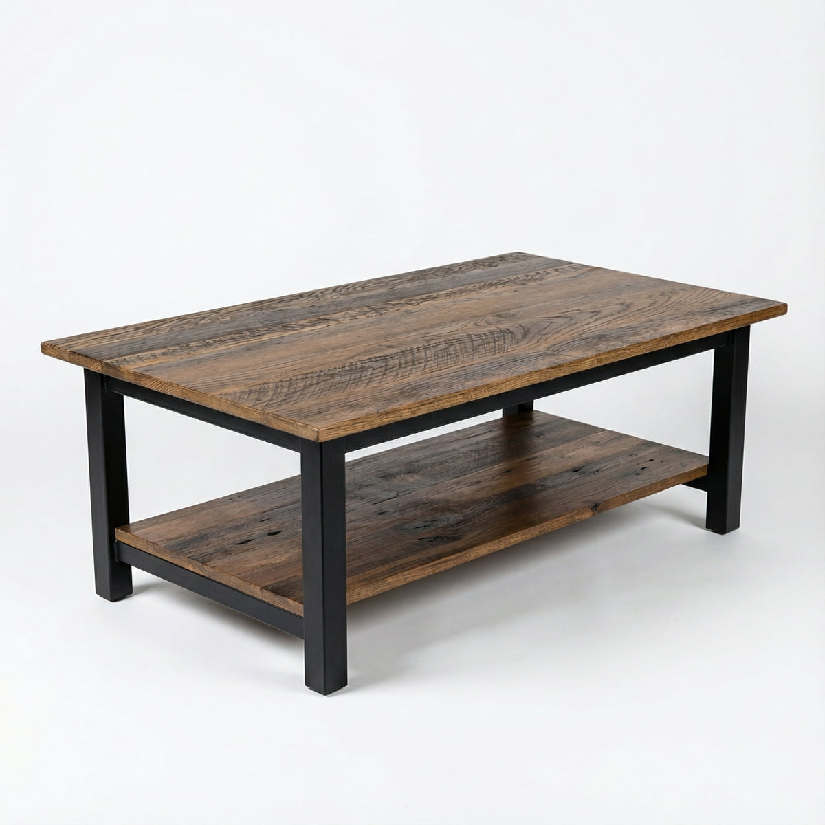A rustic rectangular coffee table made of dark brown reclaimed wood with a black metal frame and lower shelf, shown on a white studio background.