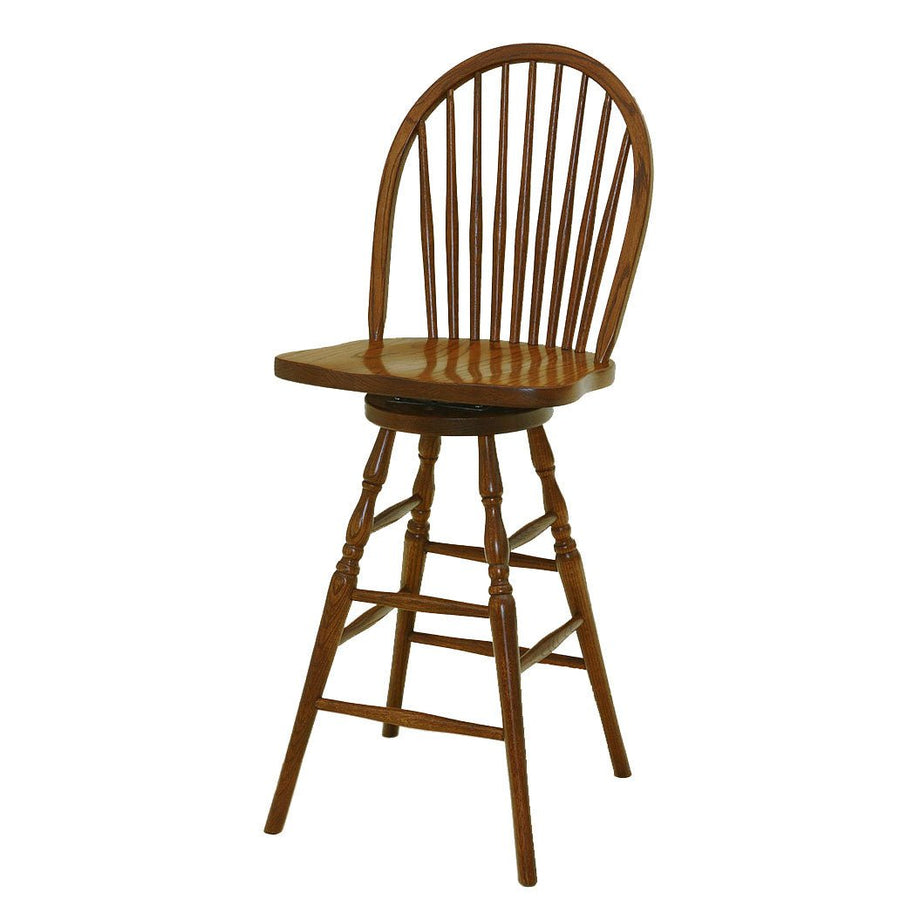 Nine spindle Windsor swivel bar stool in medium oak with bowed back, saddle seat, turned legs and double foot rails