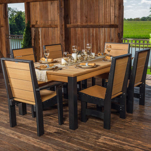 Cedar and black poly outdoor dining set with six slat-back chairs and a plank-top table set for dinner in a rustic barn