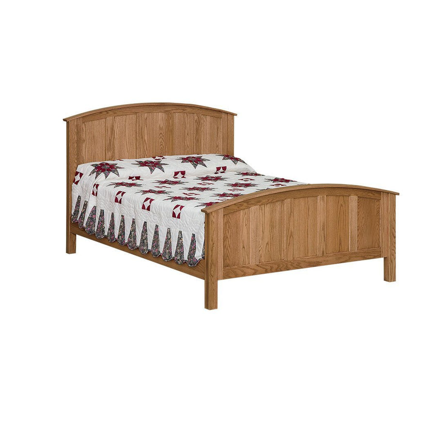 Oak curved panel bed with arched headboard and footboard and square posts, dressed in a red and white quilt