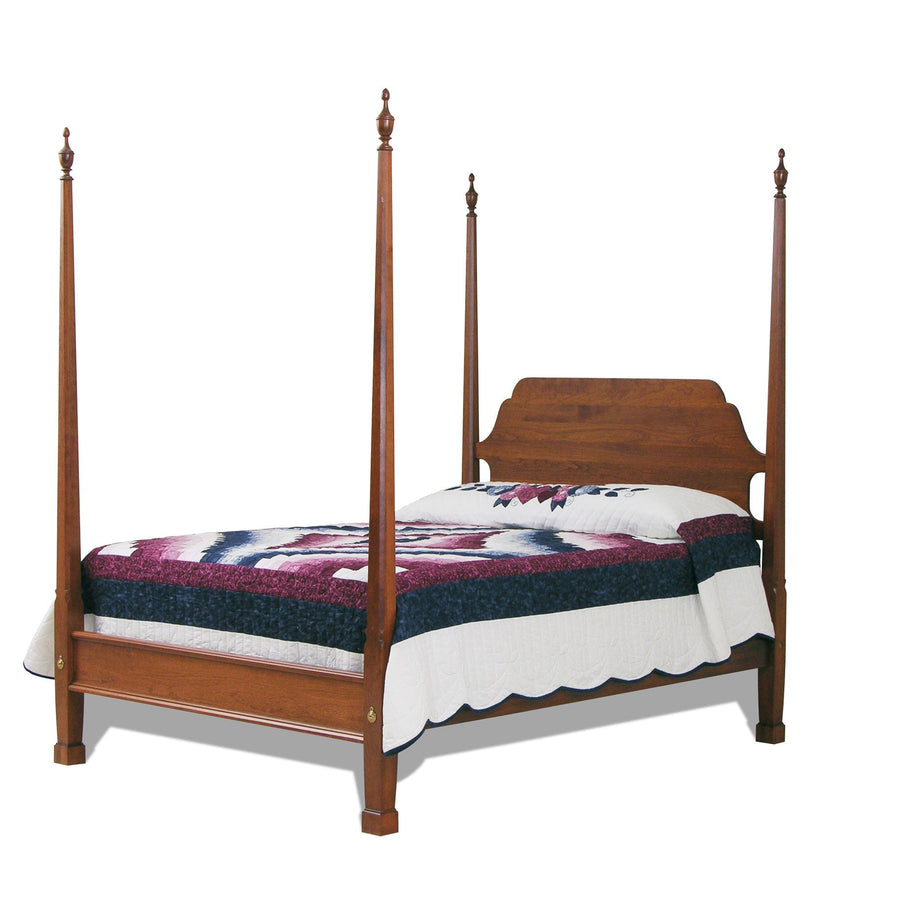 Colonial pencil post cherry bed with four tall tapered posts, urn finials and a burgundy and navy patchwork quilt