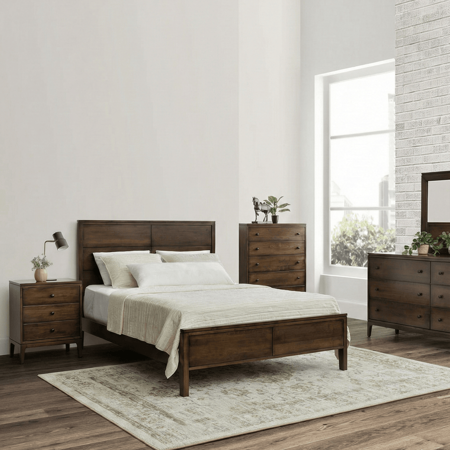 Walnut-toned mid century modern bedroom set with panel bed, nightstand, tall chest, dresser and mirror by a brick wall