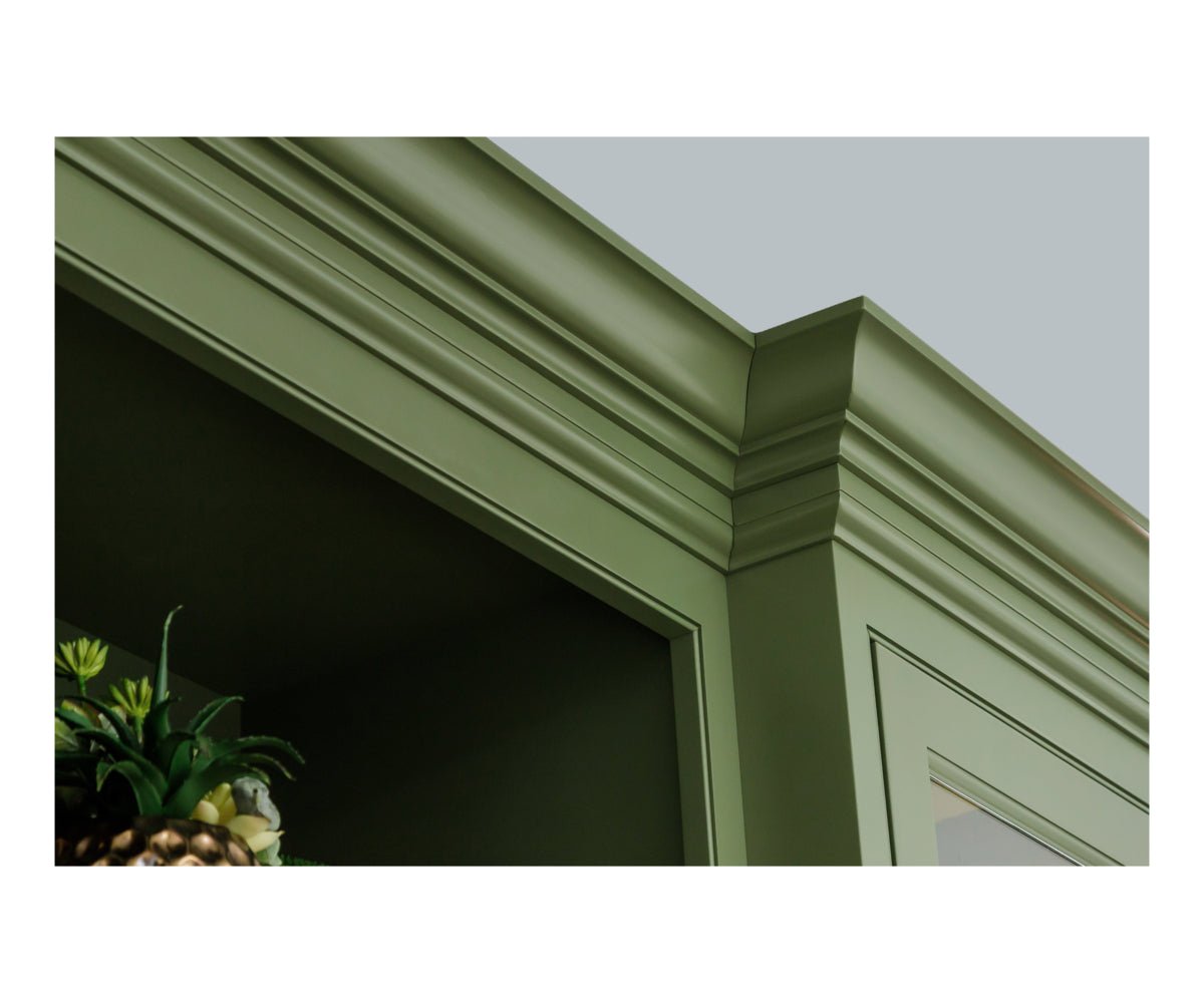 Detail of the green hutch's stepped crown molding and door frame corner