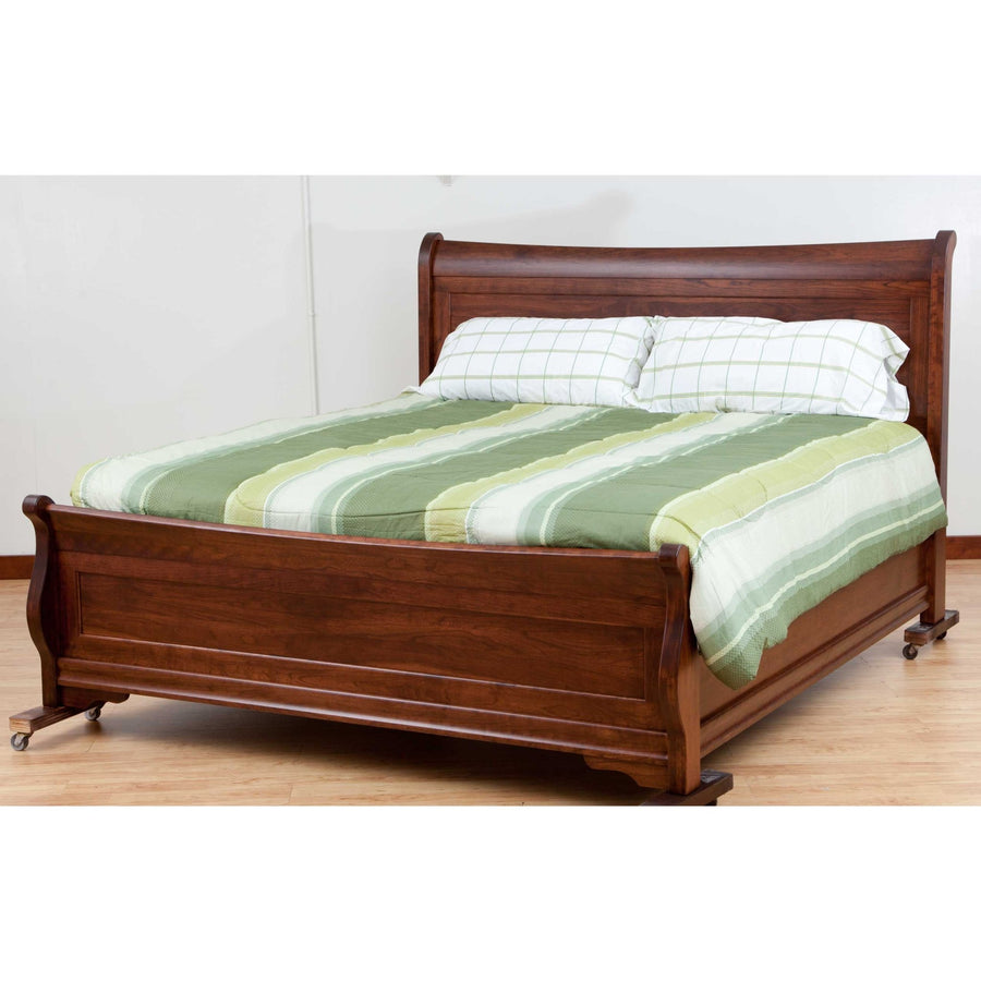 Solid cherry sleigh bed with scrolled headboard, paneled footboard and bracket feet, striped green bedding