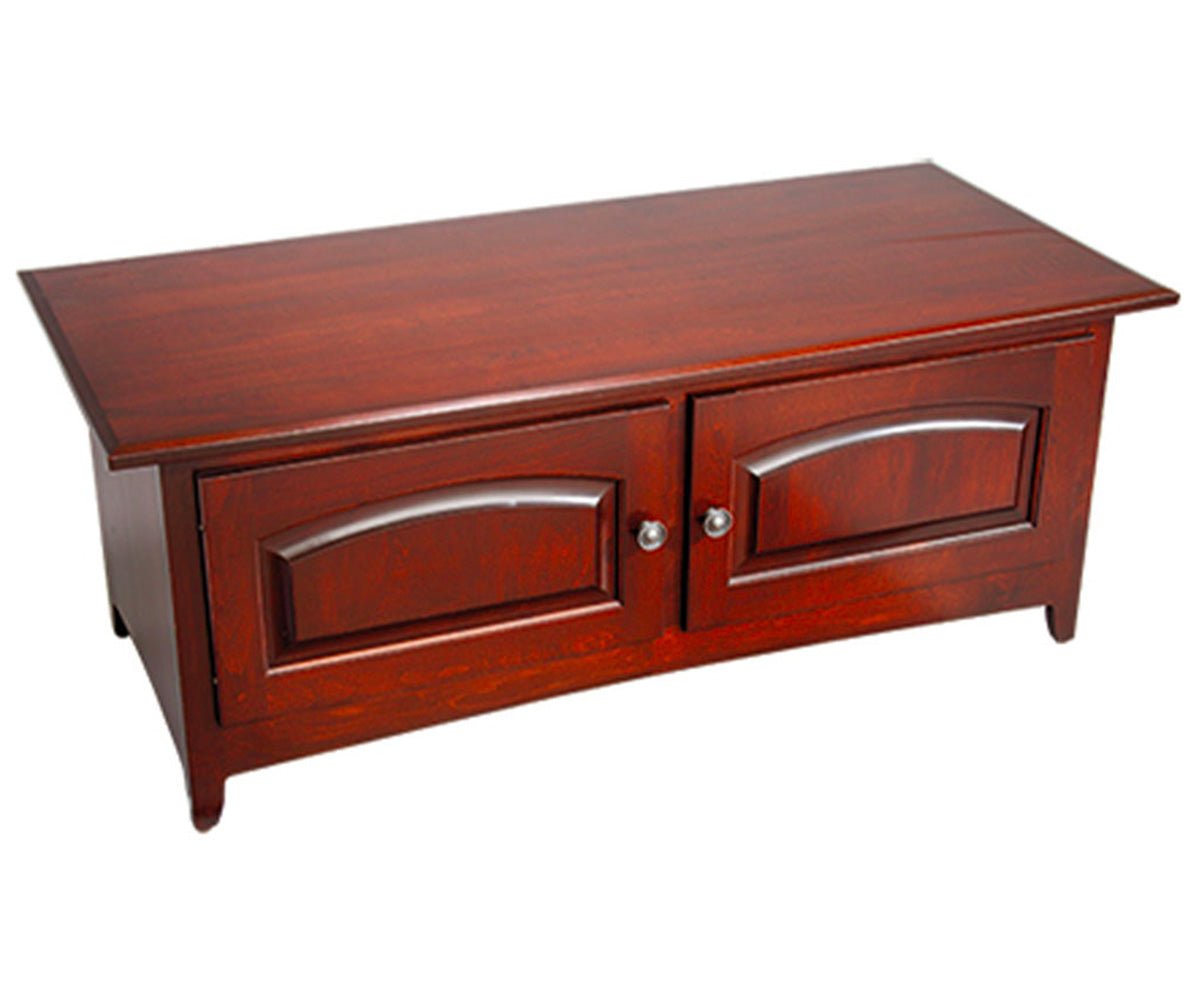 Cherry coffee table with two arched raised panel doors, nickel knobs and short flared feet, shown on a white background