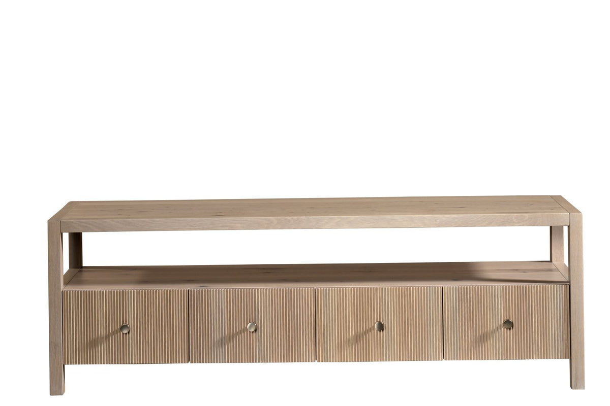 Front view of a light oak tv stand with a wide open shelf and four reeded drawers with small round pulls