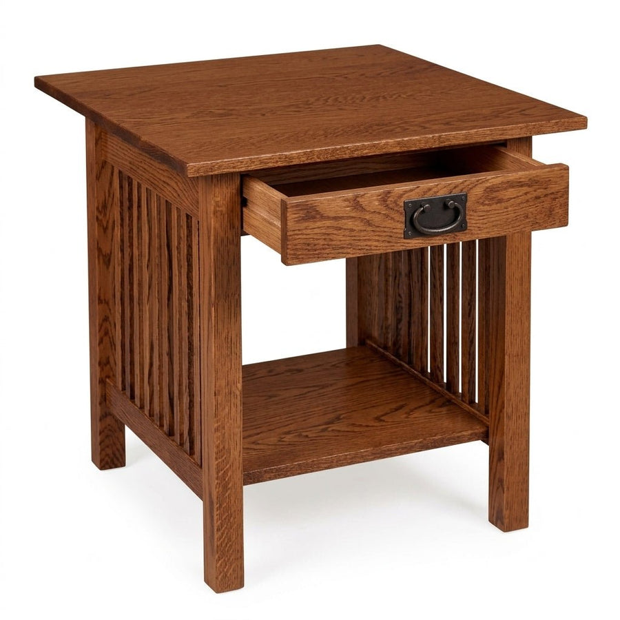 A square wooden end table with a warm medium-brown finish, featuring a single open drawer with a black metal pull handle, a slatted side panel, and an open lower shelf, shown on a white background.
