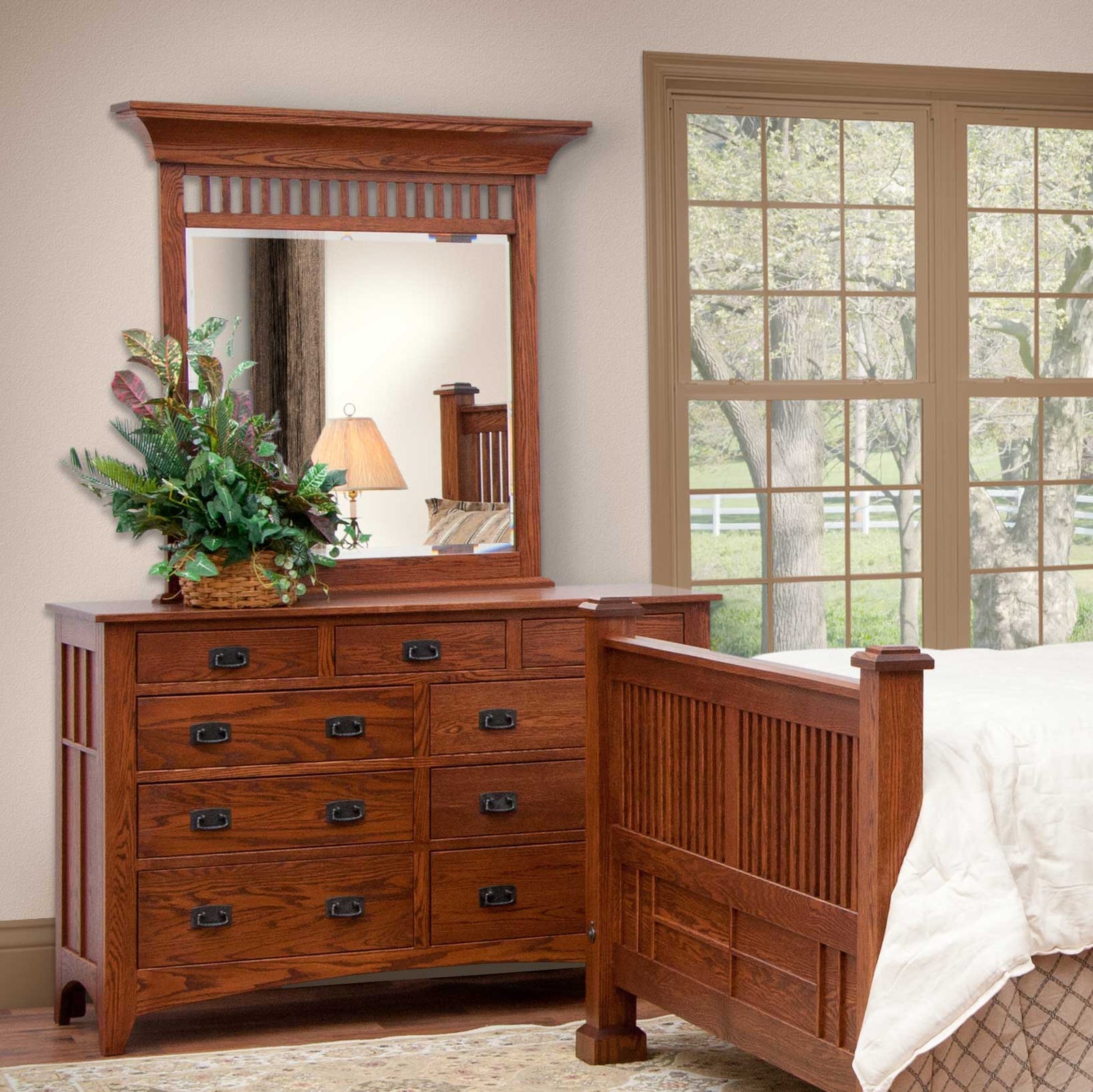 Mission oak double dresser with slatted mirror, nine drawers and black bail pulls beside a slatted bed post