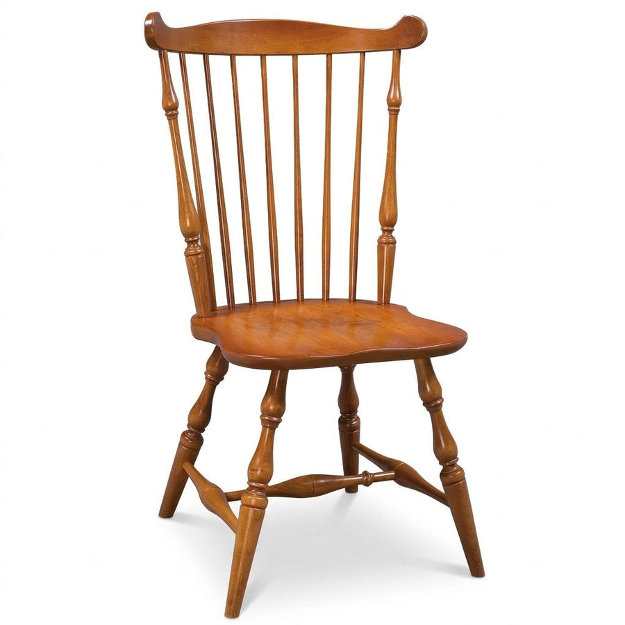 A classic wooden spindle-back chair with a warm medium-brown finish, shown from a three-quarter angle on a white background.