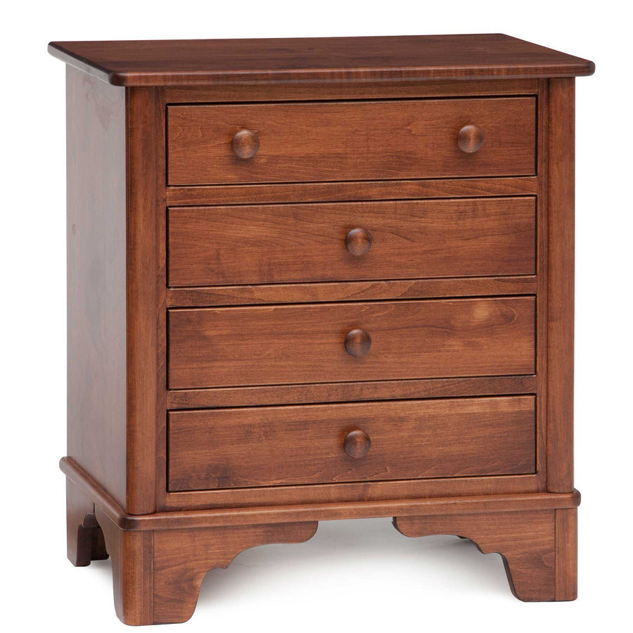 Cherry four-drawer nightstand with round knobs, beveled top edge and scalloped bracket feet on a white background