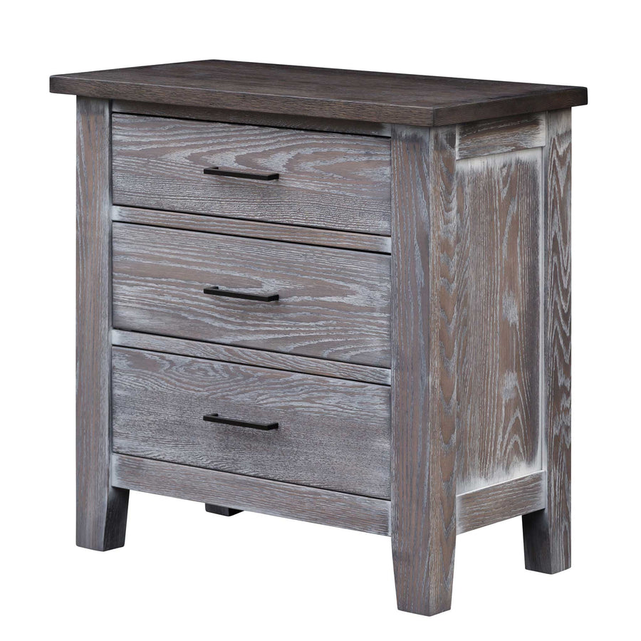 Three drawer bedside chest in brushed gray oak with dark top, black bar pulls and paneled sides