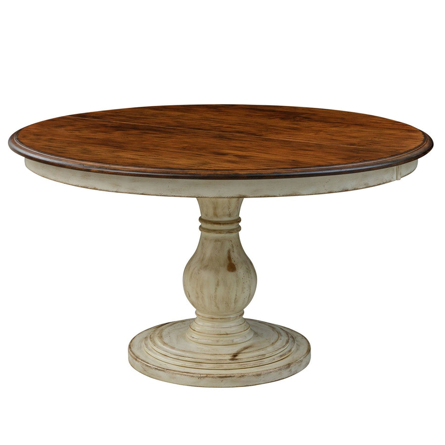 Round dining table with a rustic brown plank top on a distressed antique white turned pedestal base
