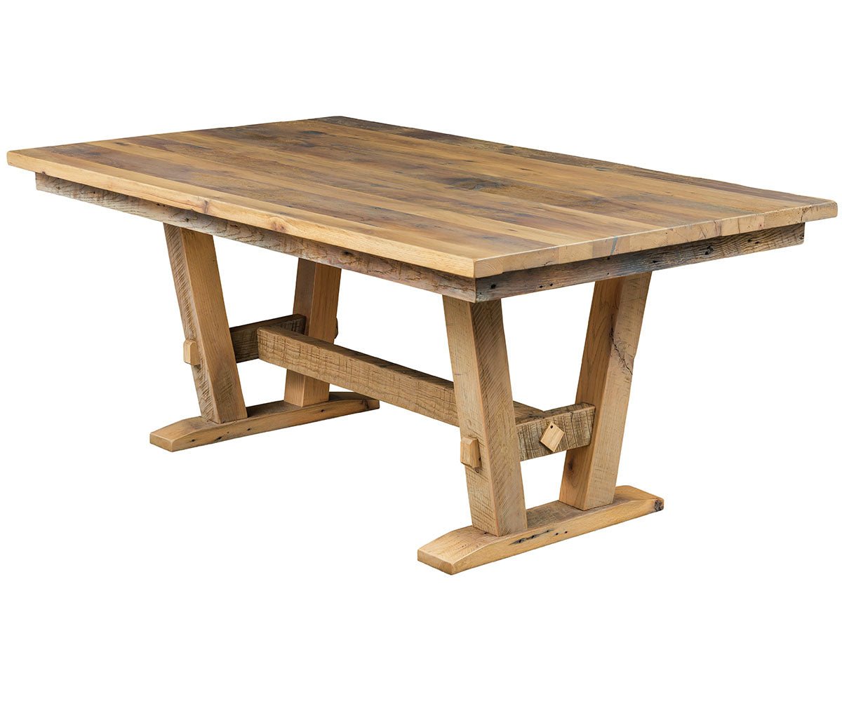 Reclaimed wood trestle farm dining table with a plank top, angled trestle legs and exposed peg joinery in a light natural finish