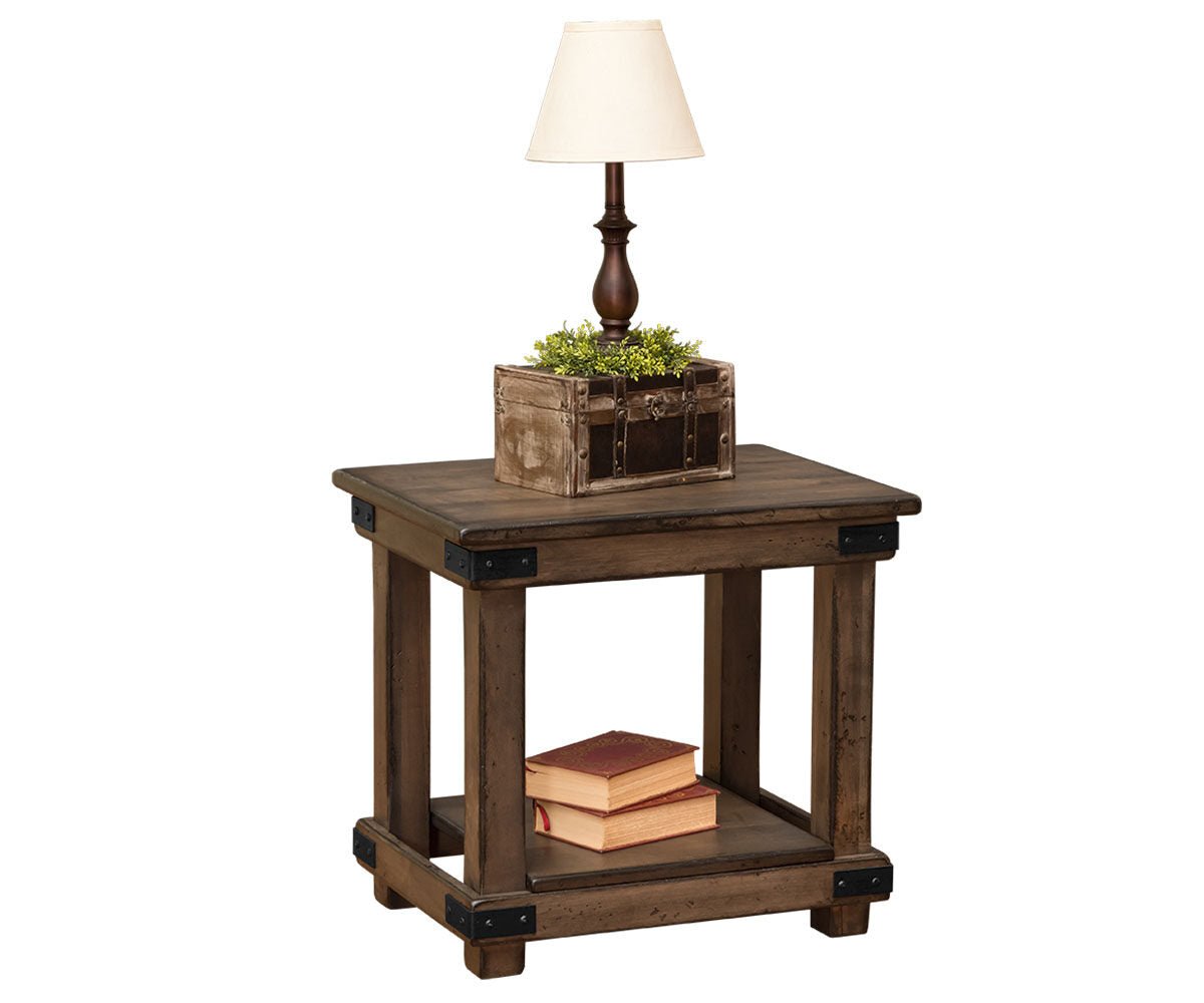 Rustic end table in distressed brown with black iron corner brackets, chunky legs and a lower display shelf