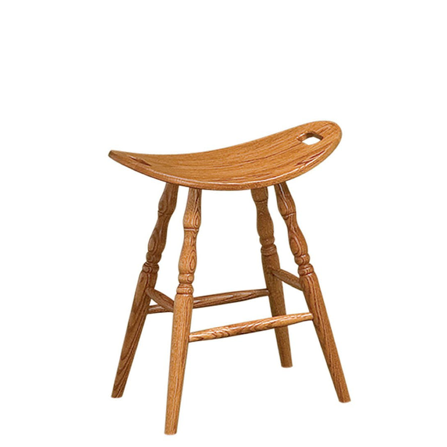 Backless oak saddle stool with a curved scooped seat, hand hold cutout, turned spindle legs and footrest rungs on white