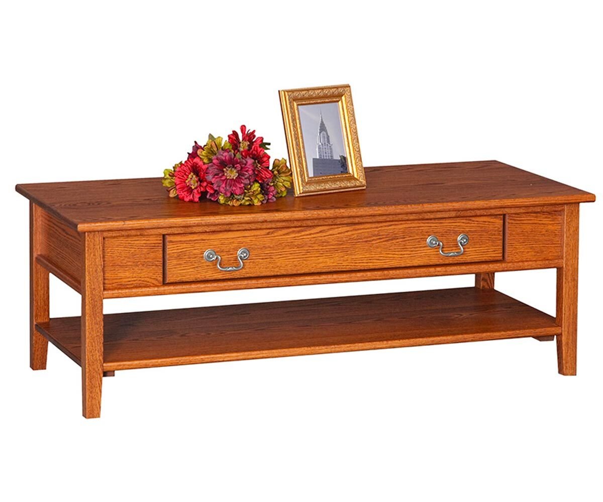 Oak Shaker coffee table with a long drawer, brass bail pulls and a lower shelf, styled with flowers and a photo frame