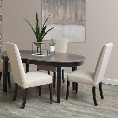 Cream upholstered parsons dining chairs with black tapered legs around an oval gray topped dining table in a modern dining room