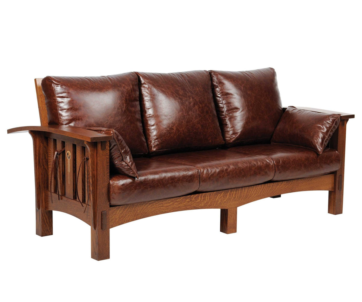 Three-cushion leather sofa on a quartersawn oak frame with slatted arms, inlay roundel and arched base rail