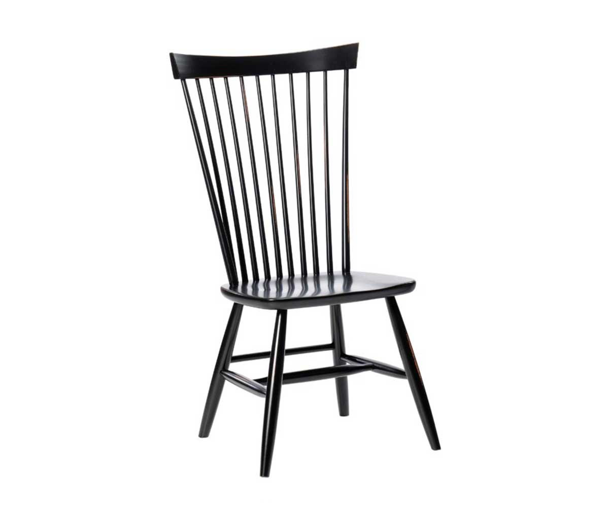 Black painted windsor dining chair with tall spindle back, saddle seat and turned splayed legs on white