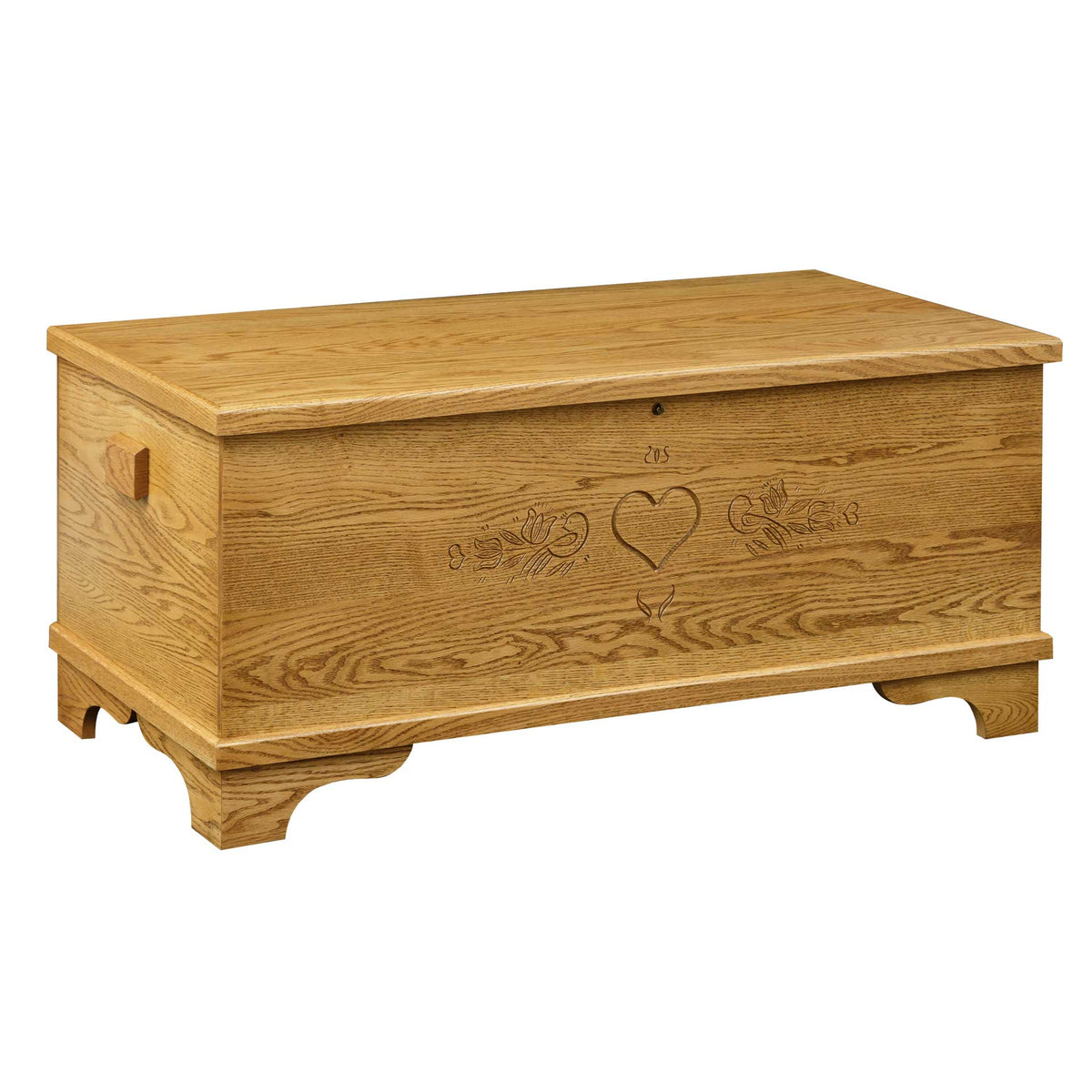 Light oak hope chest with a carved heart and tulip design, hinged flat lid and scalloped bracket base