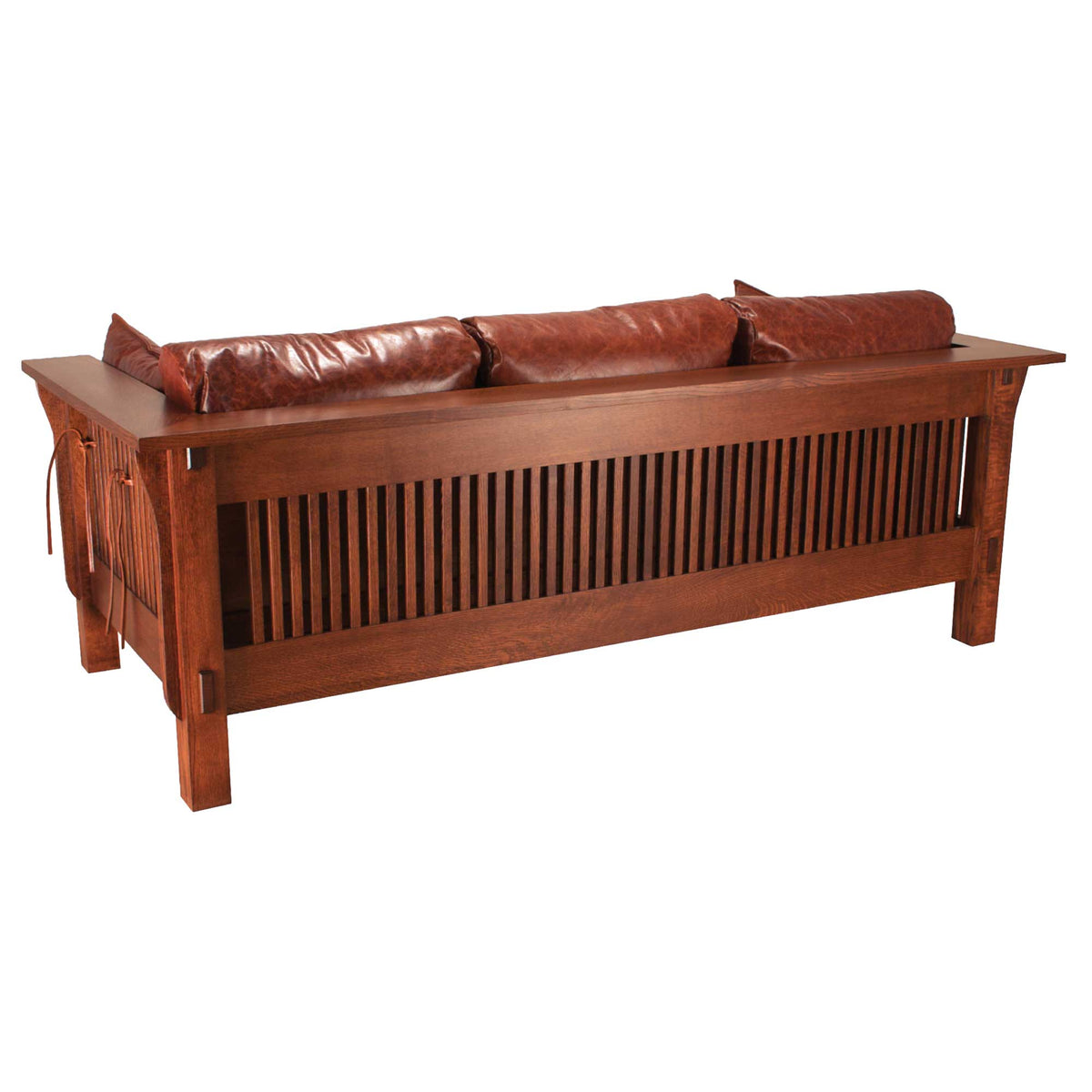 Back view of the Mission oak sofa showing its full-height spindle back panel, exposed tenons and leather lacing