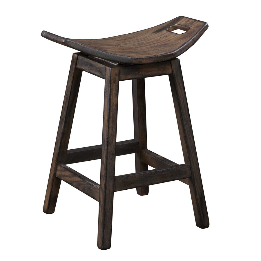 Weathered charcoal swivel saddle bar stool with a scooped seat, hand grip cutout and splayed legs with footrails