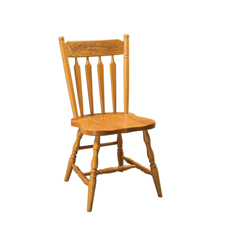 Oak arrowback side chair with a carved oak leaf and acorn crest rail, arrow spindles and turned legs