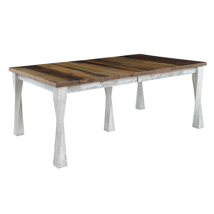 Rustic leg dining table with a multi-tone reclaimed wood top and heavily distressed white tapered legs