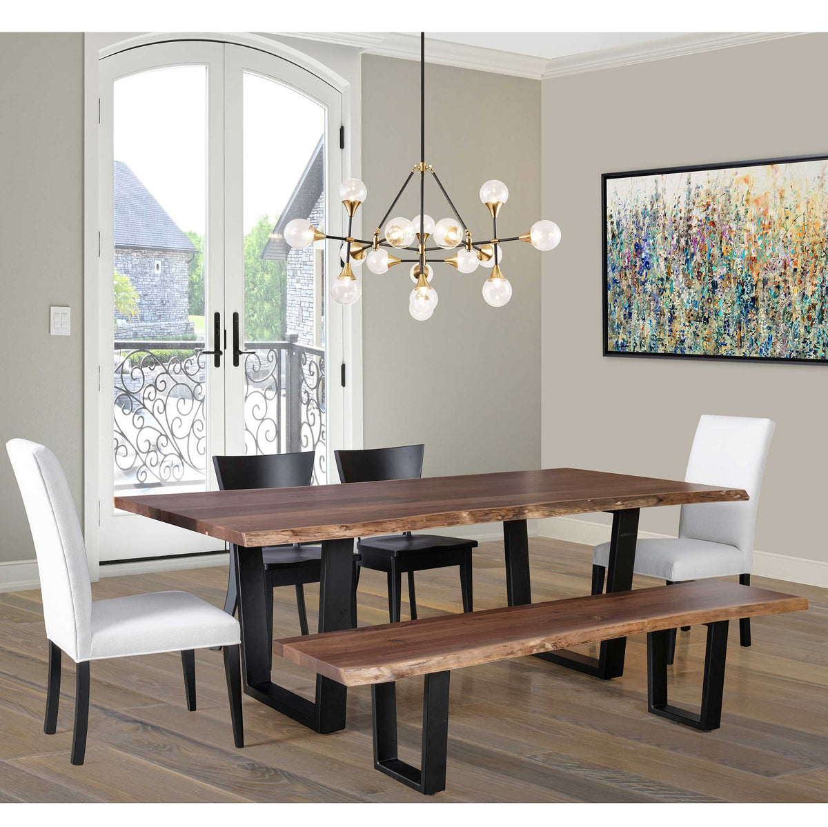 Dining room with wooden table, chairs, and bench under a modern chandelier.