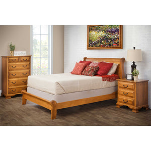 Oak sleigh bedroom set with a low footboard bed, six drawer chest and three drawer nightstand