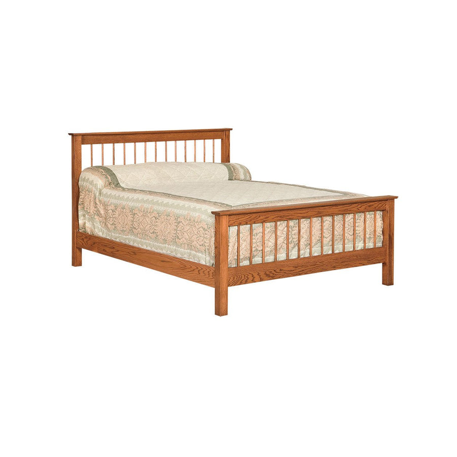 Oak spindle bed with a slatted headboard and matching slat footboard, dressed with a pastel quilt
