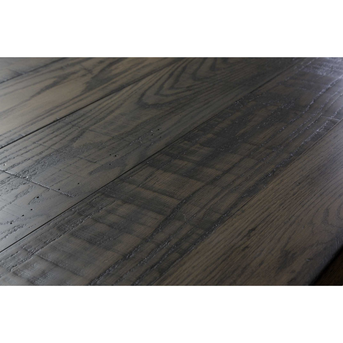 Angled view of the saw-textured gray plank table top showing grain, nail marks and plank seams
