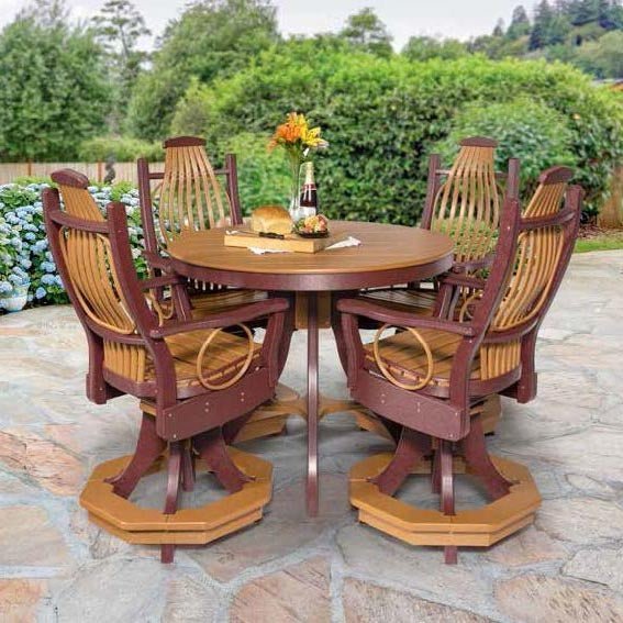 Outdoor dining set with a round cedar and cherry poly table and six swivel chairs on a stone patio