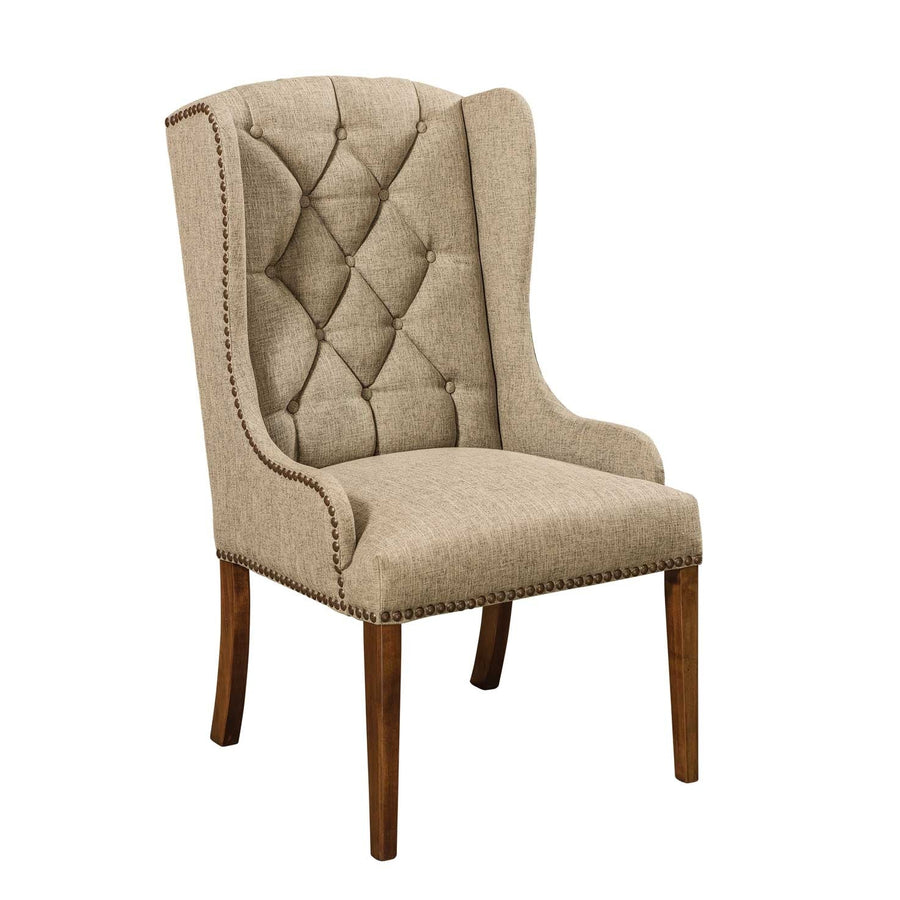 Button-tufted wingback host chair in a beige tweed fabric with antique brass nailheads and brown maple legs