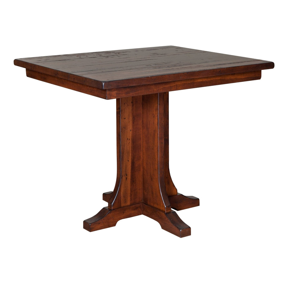 Square counter height gathering table in distressed rustic cherry with a single paneled pedestal and footed base
