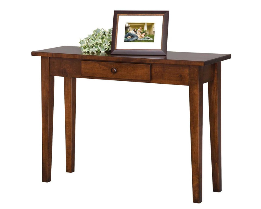 Cherry Shaker console table with a single center drawer and wooden knob, holding a framed photo and ivy garland