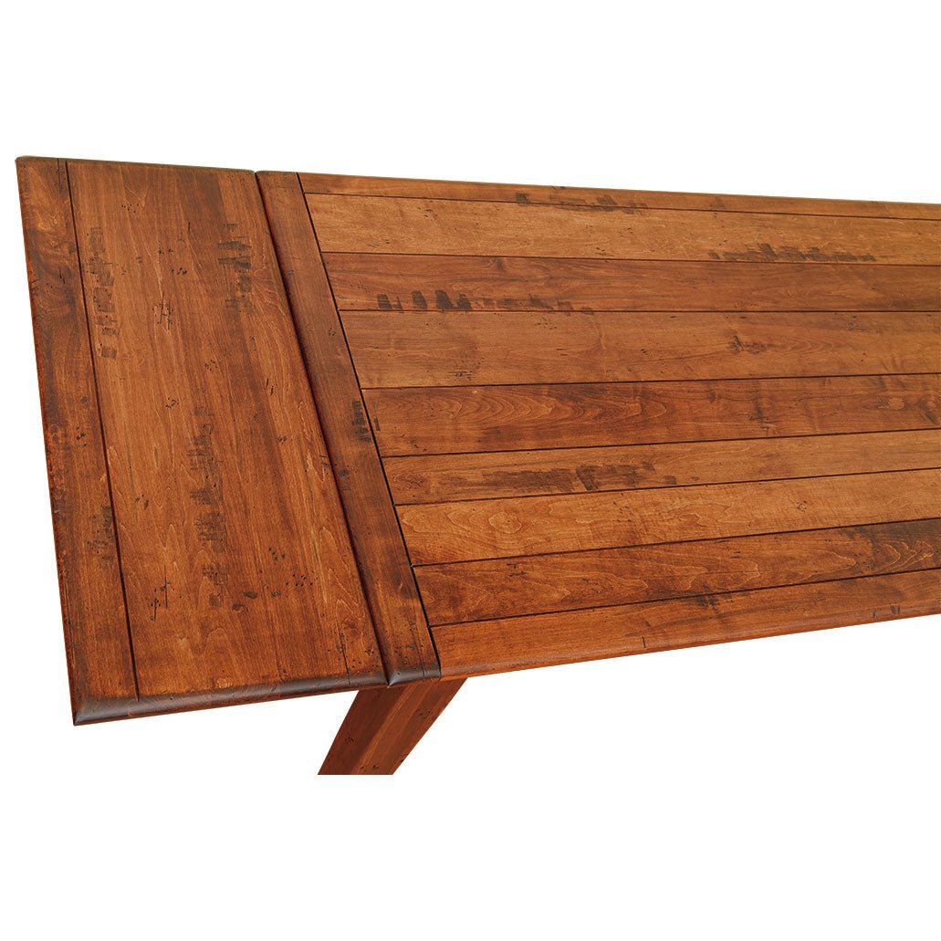 Close-up of the farm table plank top showing distressed knots, saw marks and the seam of a company board