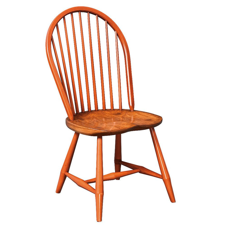 Orange painted Windsor spindle side chair with a bow back and a natural wood saddle seat on a white background