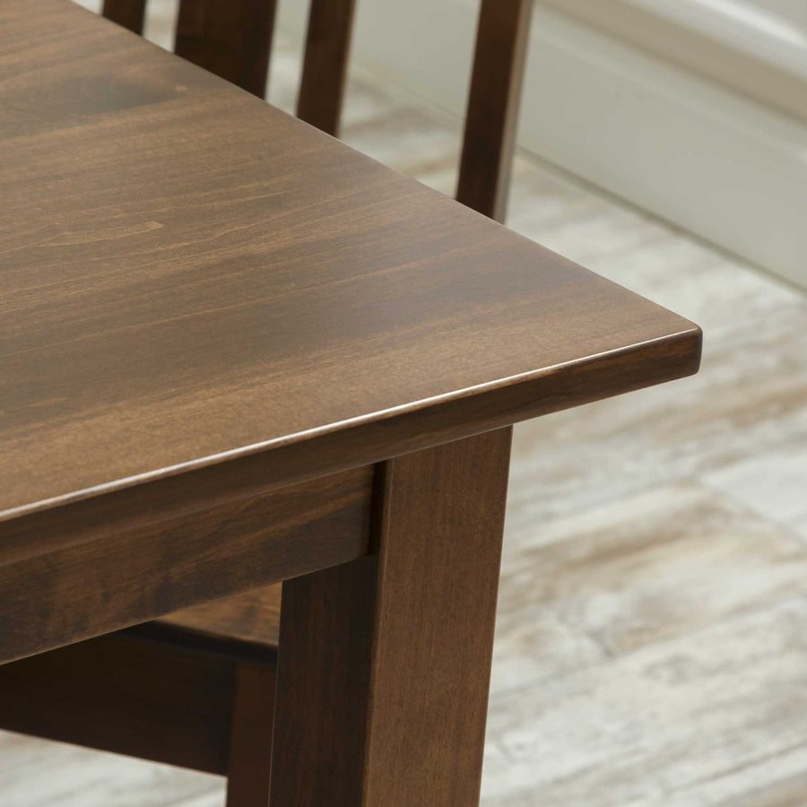 Detail of the six piece dining set table corner in rustic maple with beveled edge and straight leg