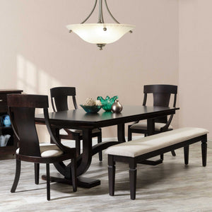 Dark espresso trestle dining table with curved arch base, matching wood-back side chairs and an upholstered bench in a dining room